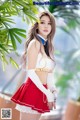 A woman in a red and white outfit posing for a picture.