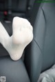 A pair of white socks sitting on the back seat of a car.