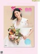 A magazine with a woman holding a bouquet of flowers.